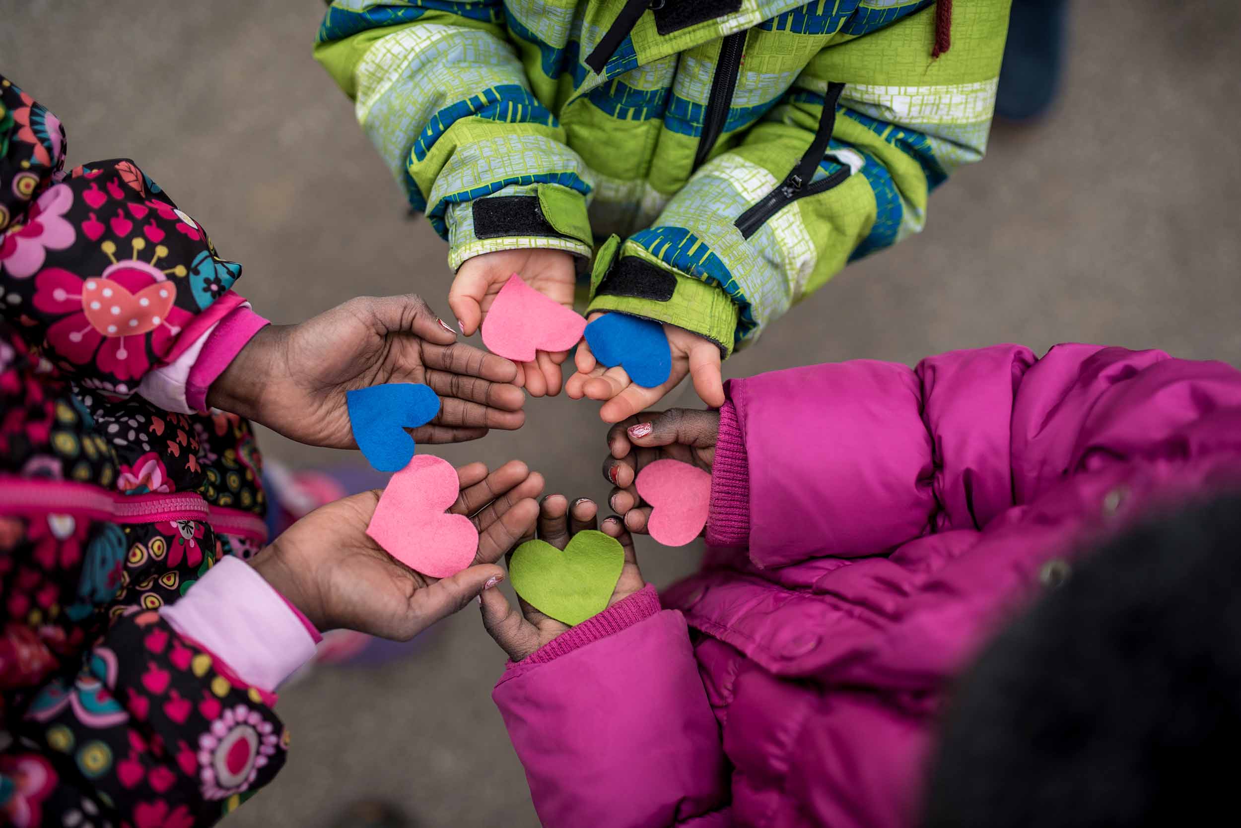 Children holding hearts in hands