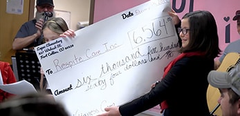 Child with a large check